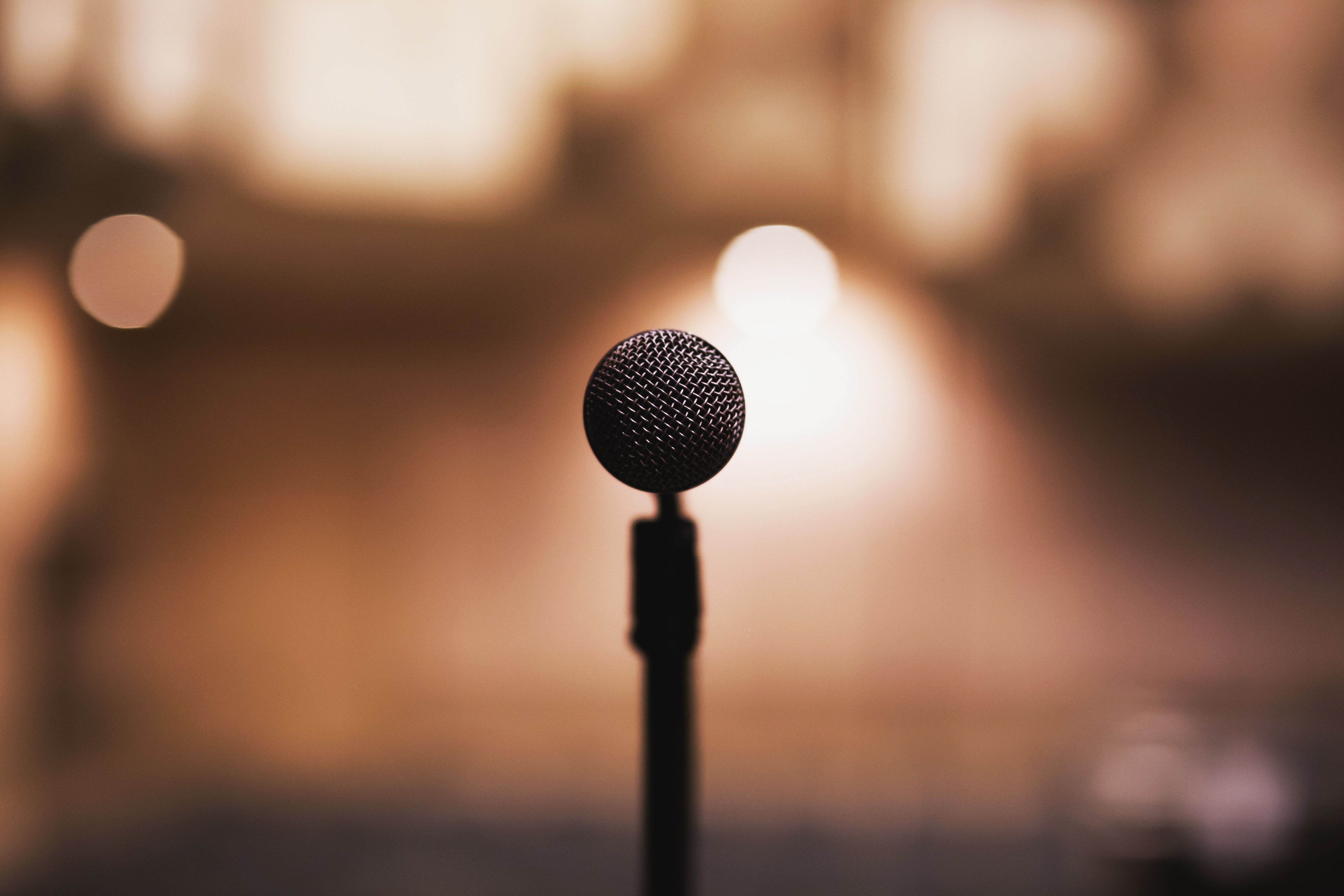 microphone on a microphone stand with blurred theatre in background