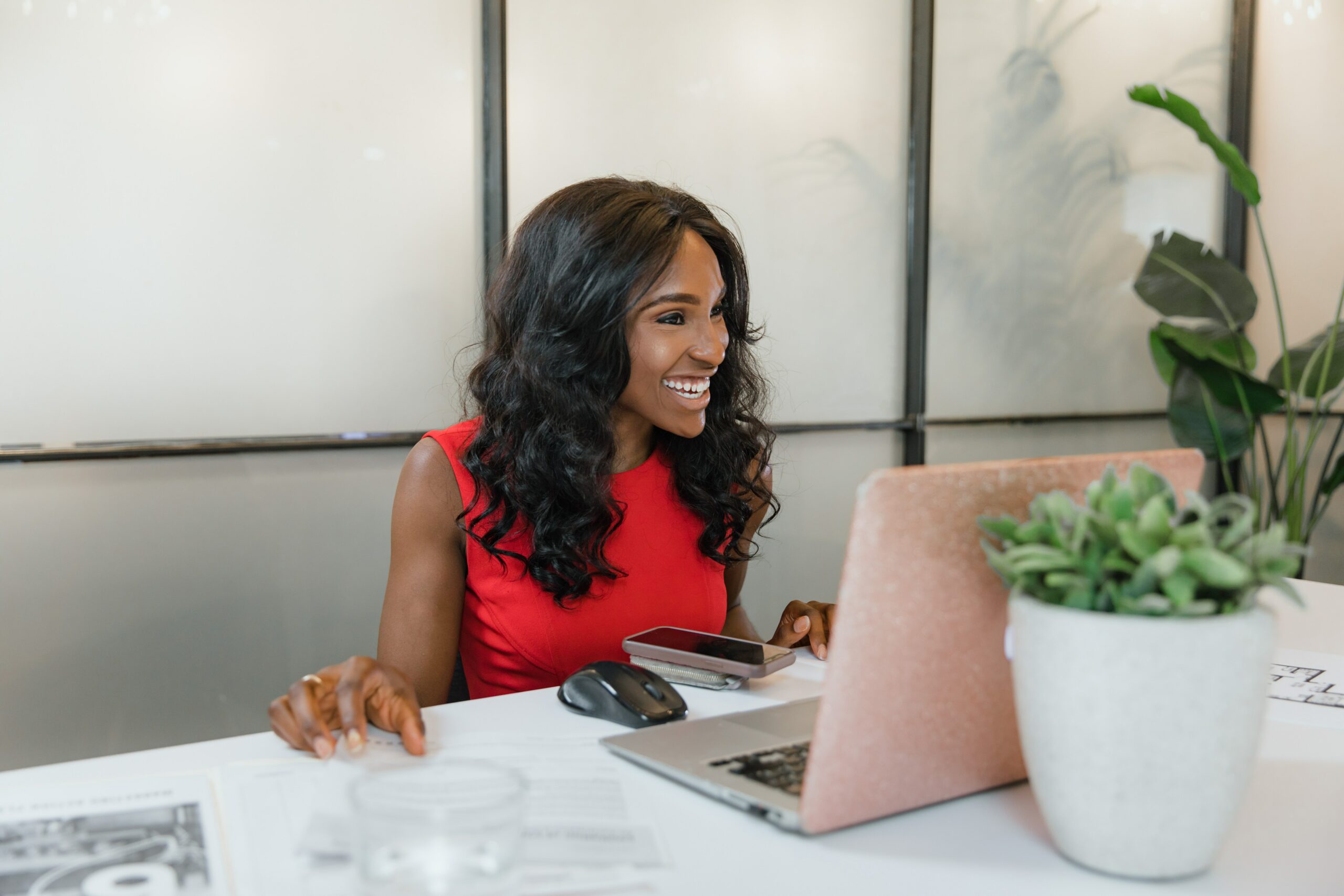 Business woman in red dress sits happy her great good description found her the perfect candidate